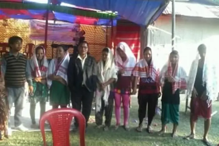 group of people before baptism under awning